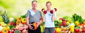 Healthy senior couple over fresh fruits and vegetables background.